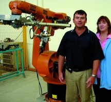 Karl Du Preez and Charmaine van Huyssteen with one of the Kuka robots in the Robotics Laboratory at NMMU